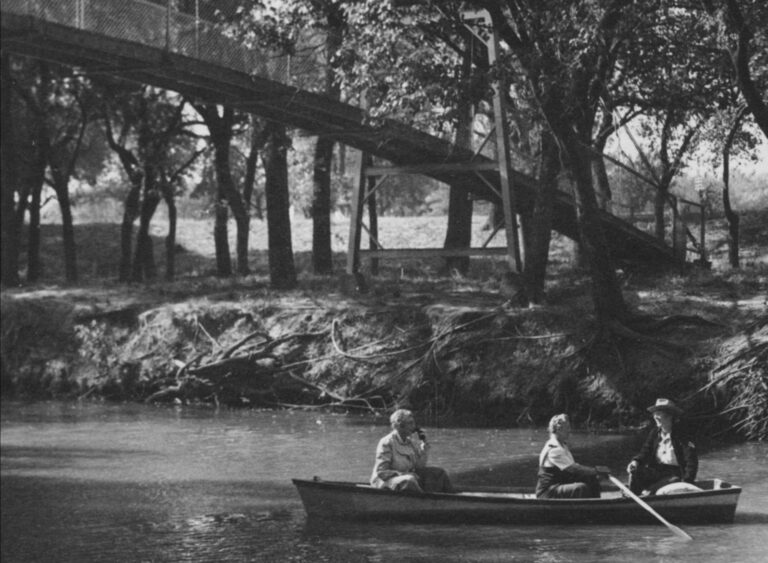B&W photo of Edna and Alma Ruth and a companion boating on the Little Arkansas River near Halstead