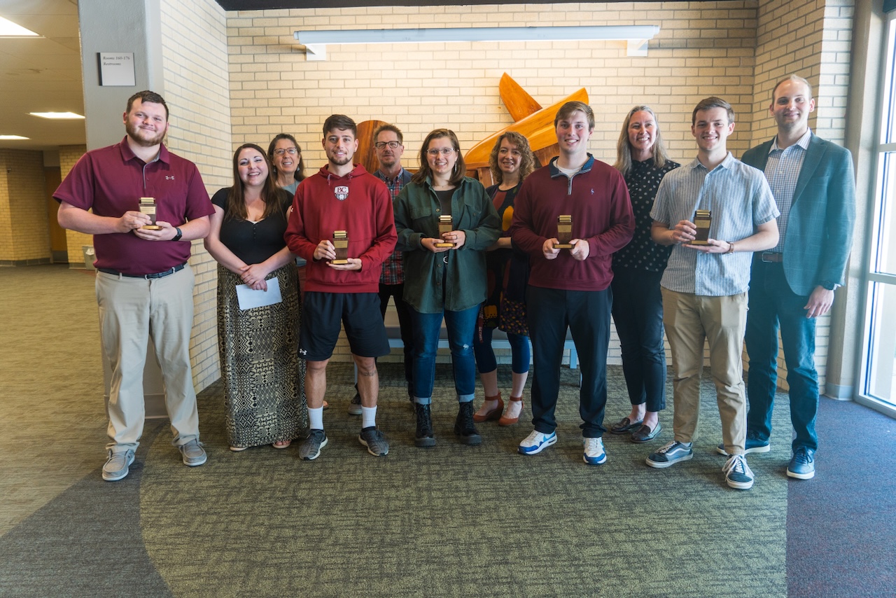 Five students in front holding their Thresher Awards, with presenting faculty standing behind them