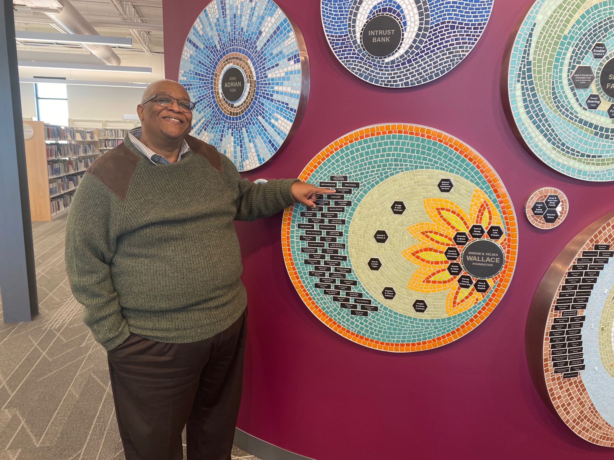 Larry Lee with Newton Public Library mosaic plaques