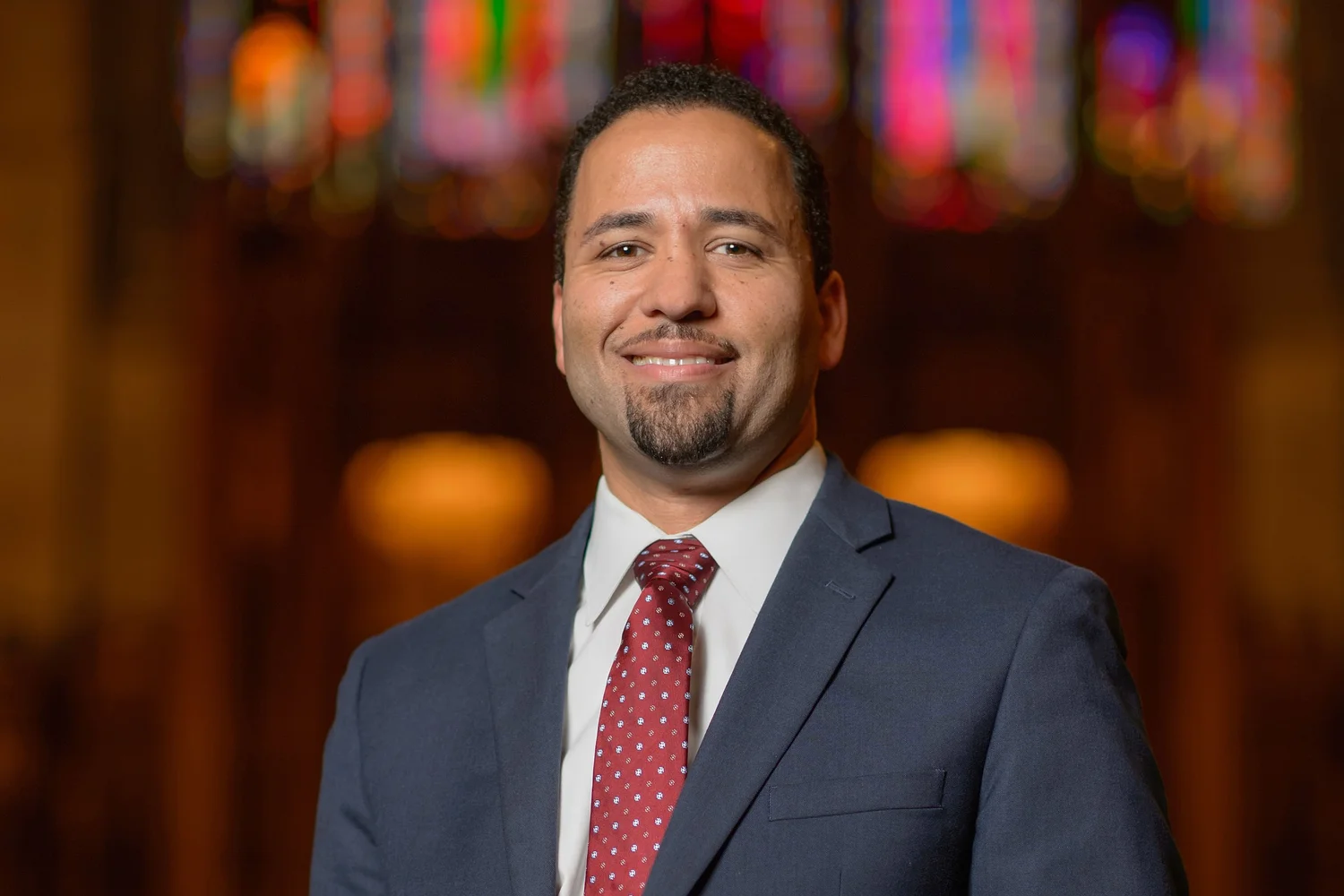 Headshot of Luke Powery in dark blue coat and red tie