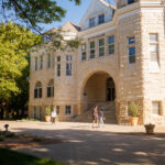 People walking in front of the Administration Building on a sunny day