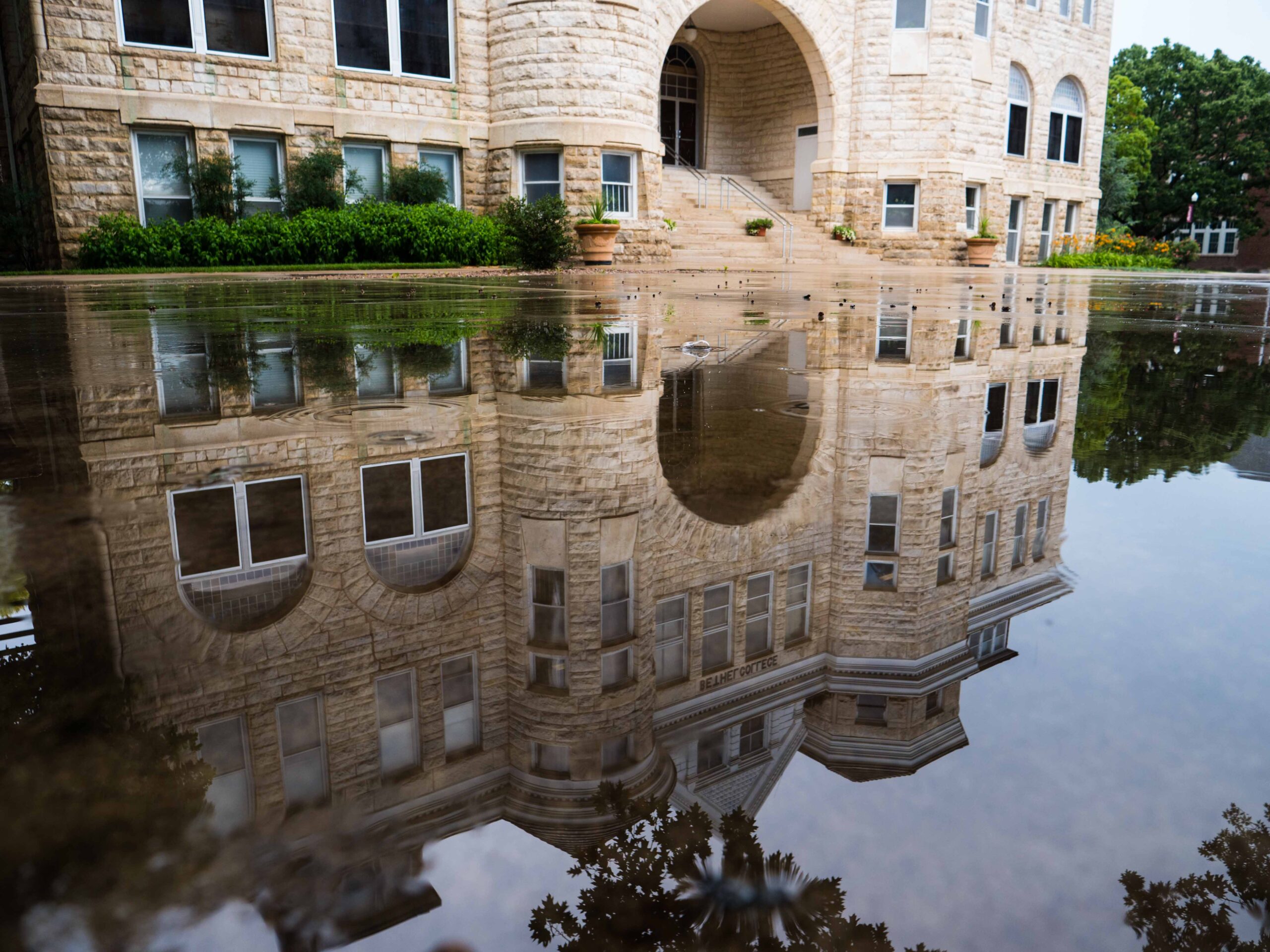 Ad Building reflected in a pool of water